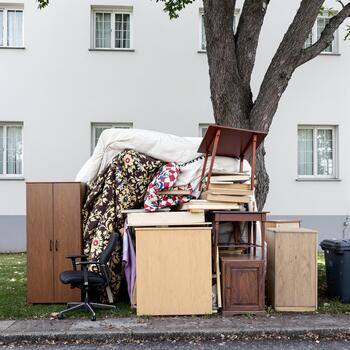 Household furniture and belongings gathered for a property cleanout