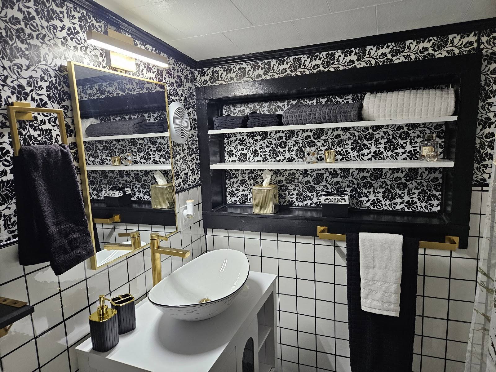 Completed bathroom sink, mirror, and built-in shelving after the refresh