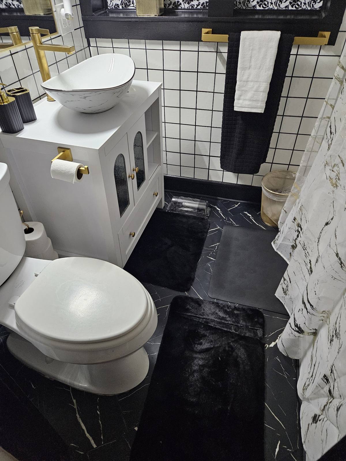 Second view of the completed bathroom showing the vanity and floor